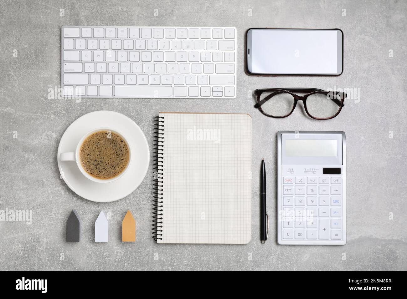 Flat lay composition with computer keyboard, calculator and notebook on grey table Stock Photo