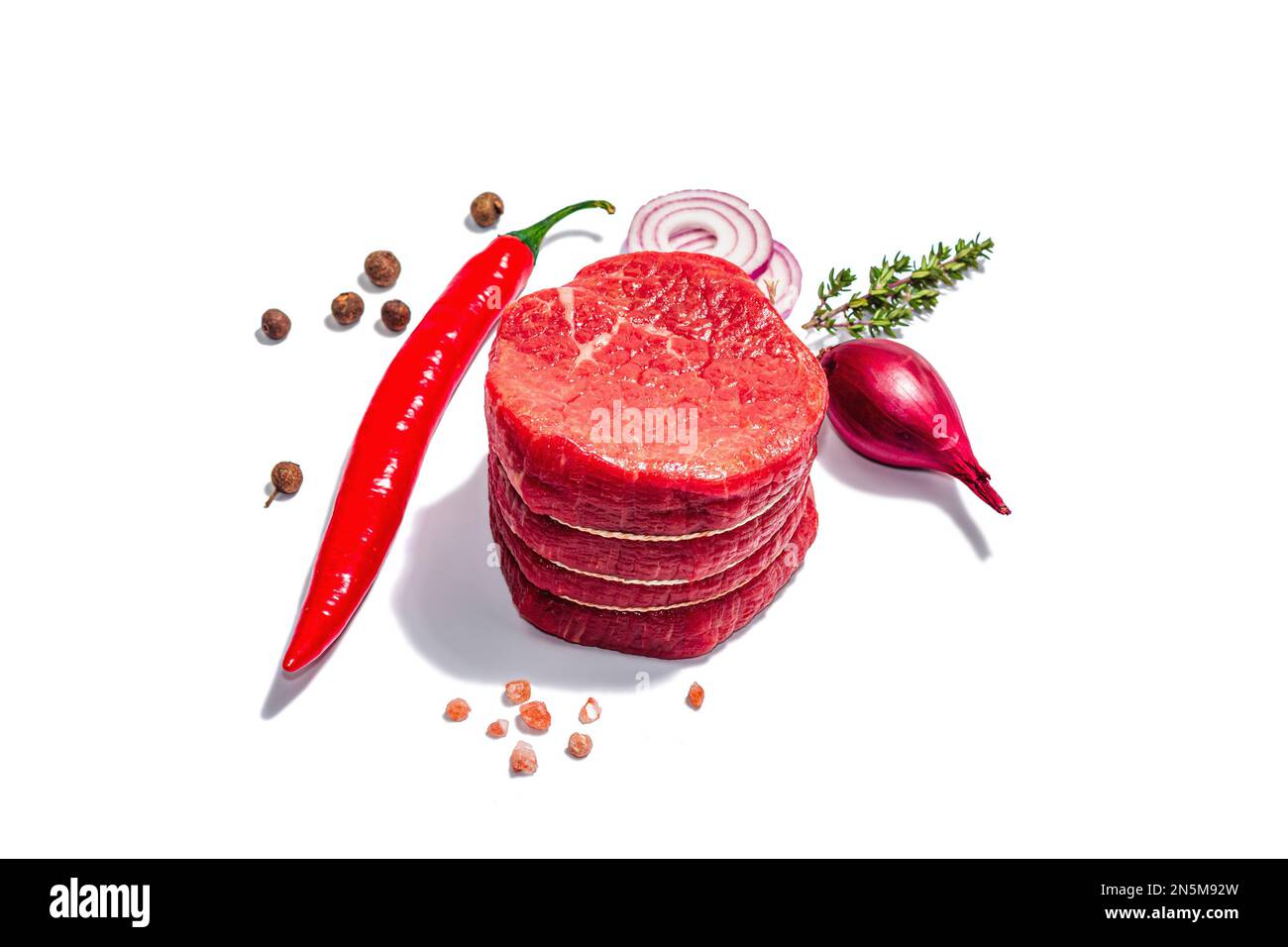 Raw Eye of round steak with spices and herbs isolated on white