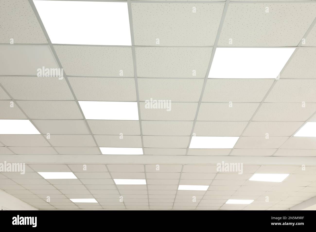 White ceiling with lighting in office room Stock Photo