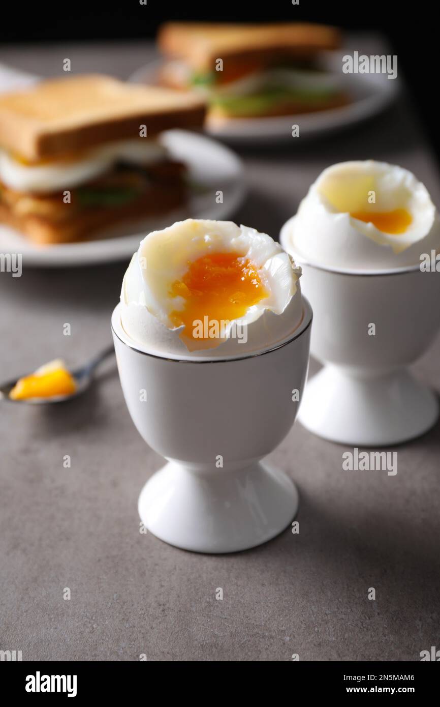 https://c8.alamy.com/comp/2N5MAM6/soft-boiled-eggs-served-for-breakfast-on-grey-table-closeup-2N5MAM6.jpg