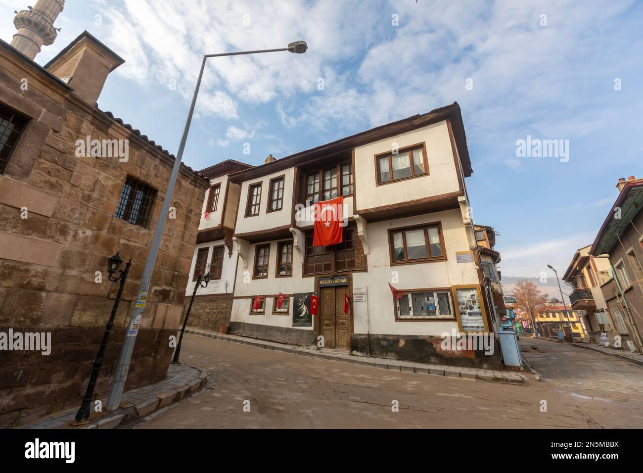 Street with traditional turkish ottoman houses in Afyonkarahisar old town. Afyonkarahisar cityscape Afyon castle on the rock, Stock Photo