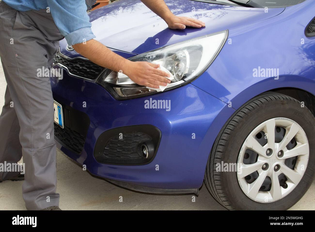 Image of a body shop while polishing the headlights of a car. Stock Photo