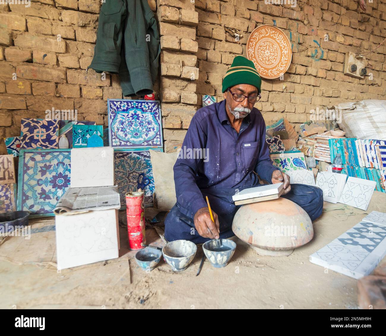 Hala Sindh 2022, an old Man is making Colorful blue clay tiles in Hala