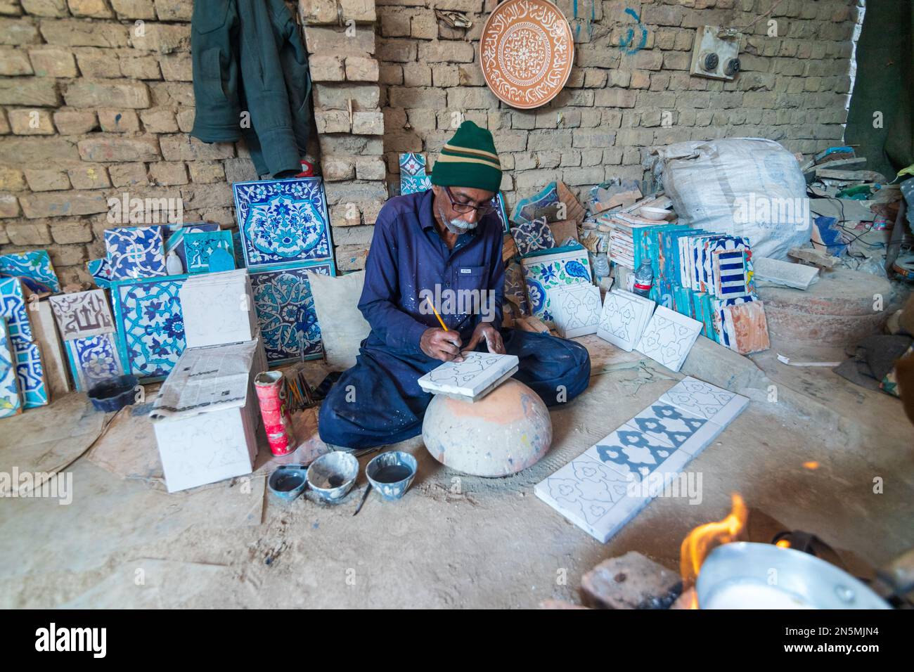 Hala Sindh 2022, an old Man is making Colorful blue clay tiles in Hala
