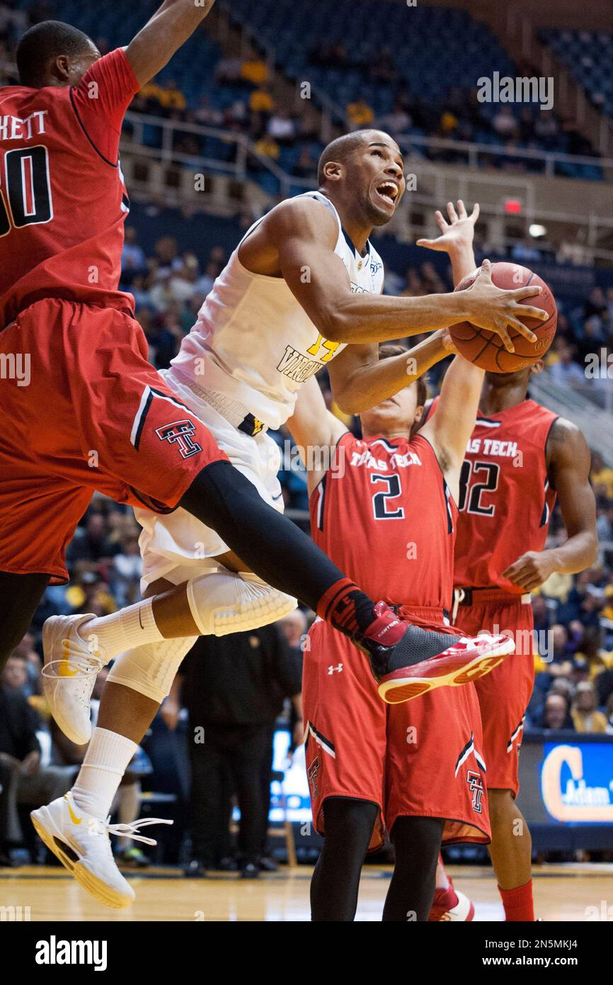 West Virginia's Gary Browne, right, looks to shoot during the second