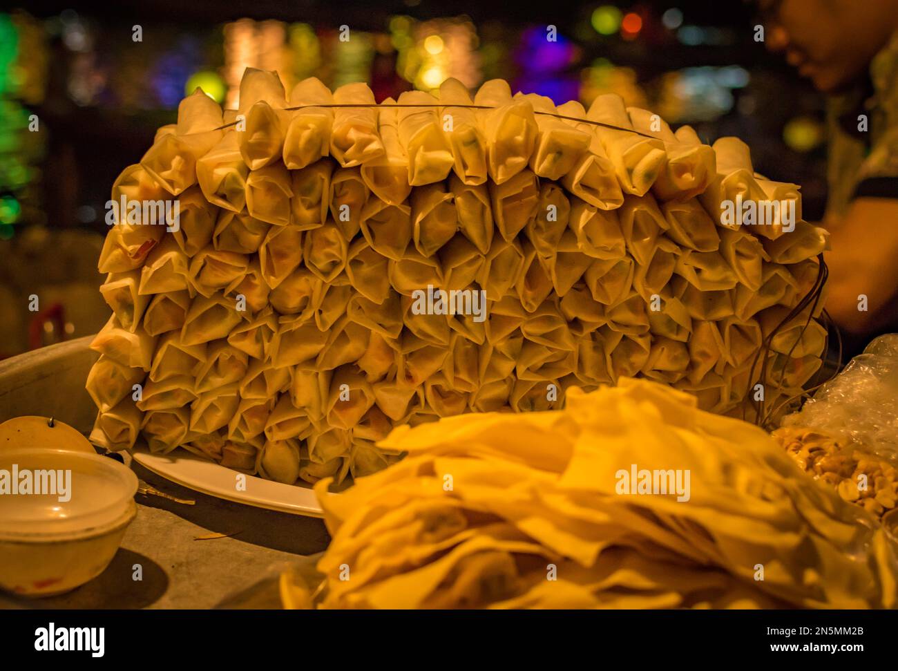 A pile display of spring rolls by night in Hoi An, Vietnam. Stock Photo