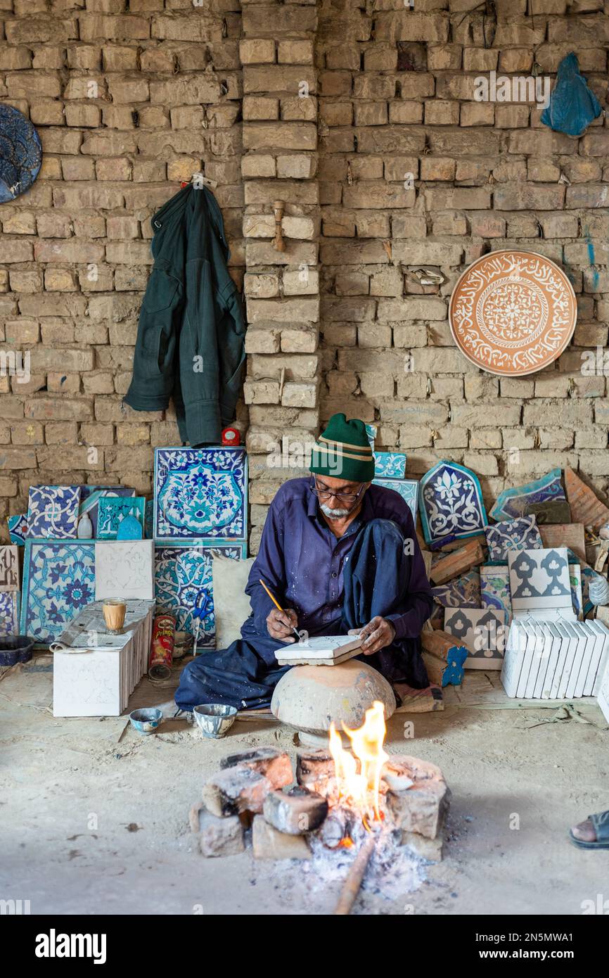 Hala Sindh 2022, an old Man is making Colorful blue clay tiles in Hala