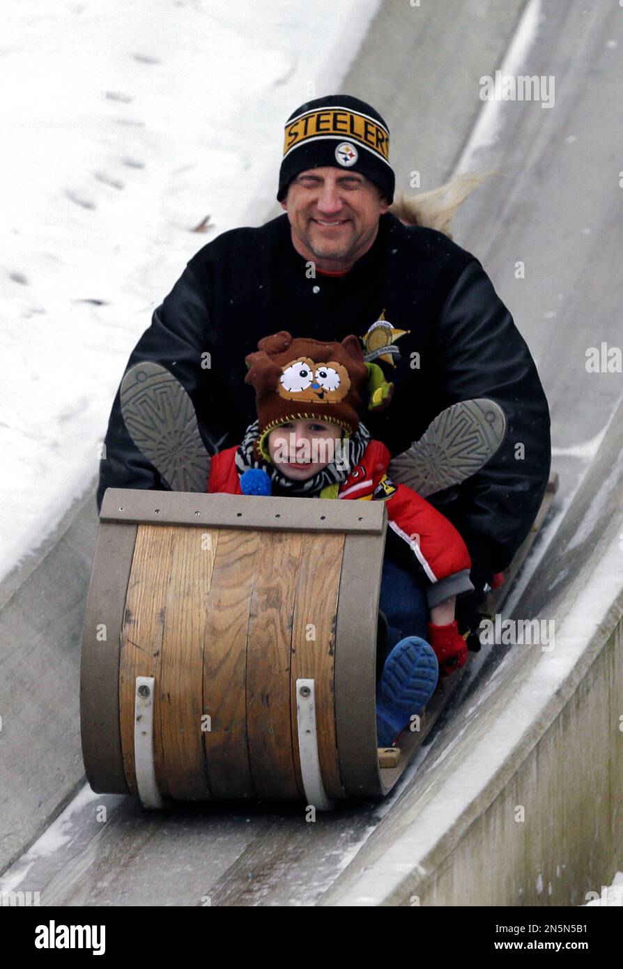 Jake Chalmers, front, and his father Phil, ride down the Cleveland