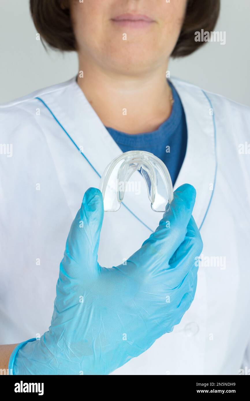 Teeth Whitening Tooth Tray in doctors hand, Closeup. Invisible