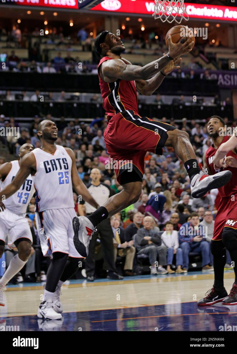 Miami Heat's LeBron James, top, drives past Charlotte Bobcats' Al