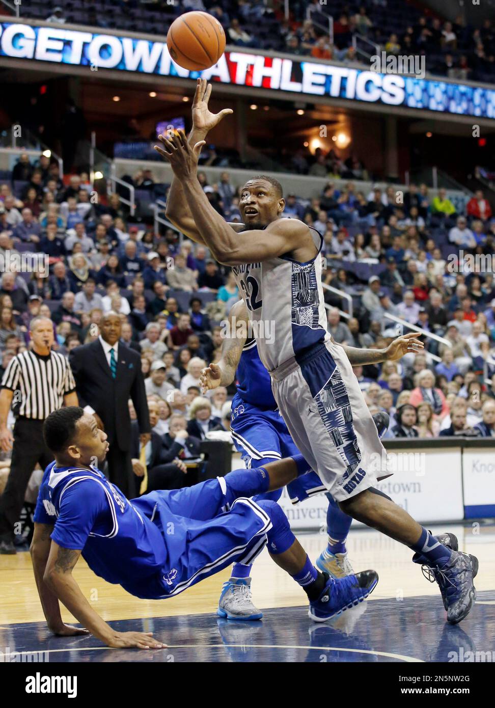 Georgetown center Moses Ayegba (32) shoots as he falls along with Seton ...