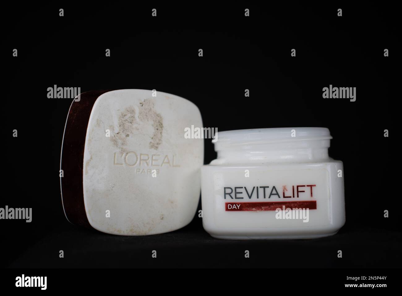 EXETER, DEVON, UK - JANUARY 9, 2023  L'Oréal S.A. is a French personal care company product Revitalift Day cream half used lid on one side Stock Photo