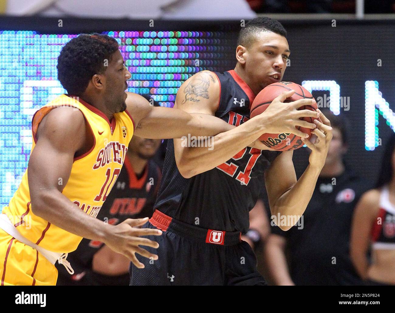 Southern California's Pe'Shon Howard (10) and Utah's Jordan Loveridge (21)  vie for the ball in the first half during an NCAA college basketball game  Thursday, Jan. 16, 2014, in Salt Lake City. (