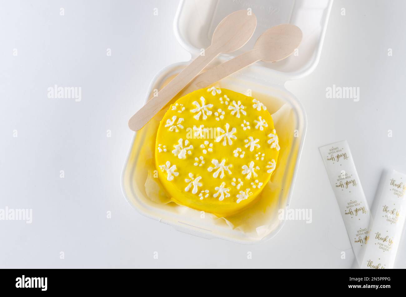 Trendy bento cake yellow color with cute decor on light background ...