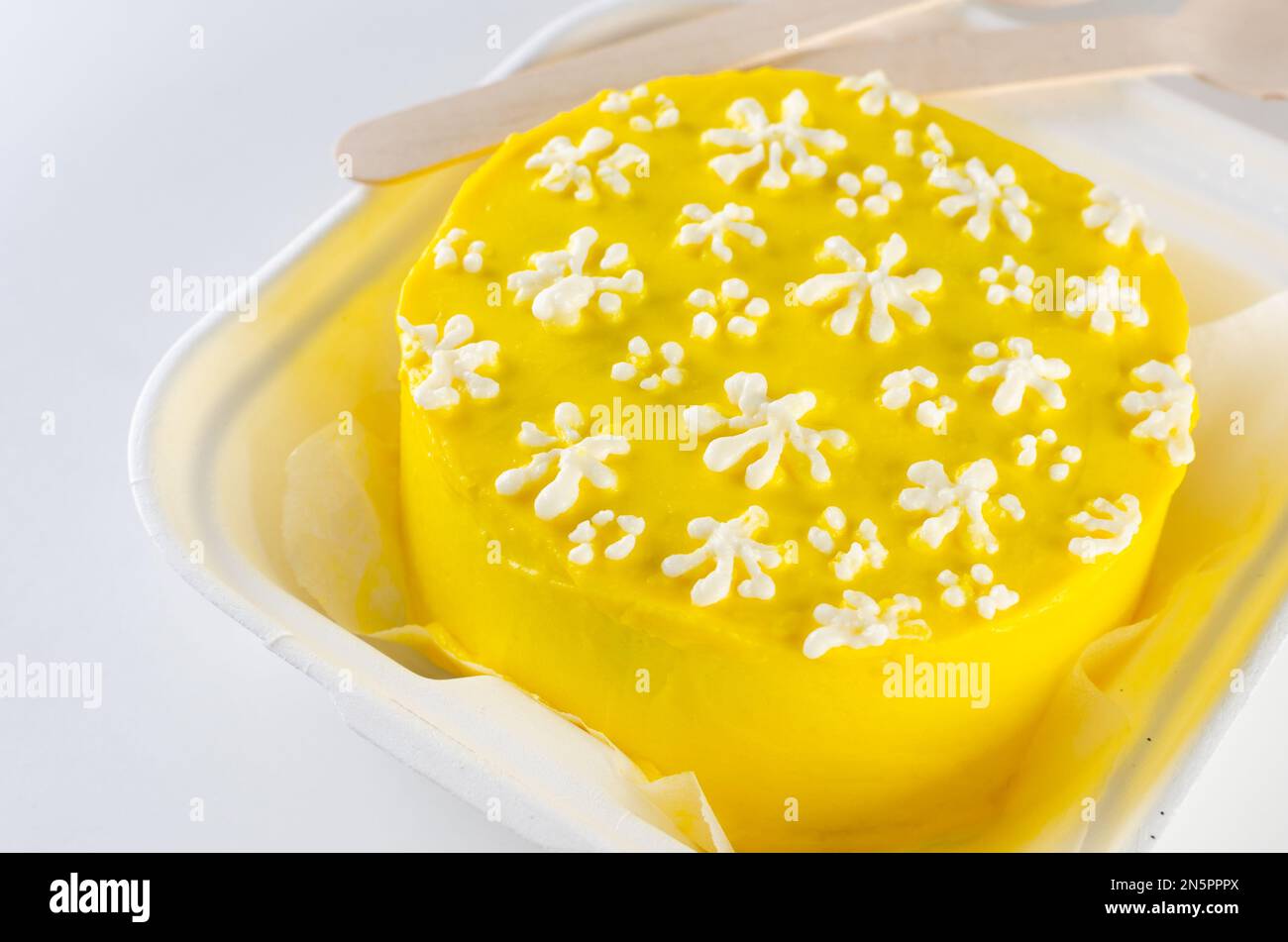 Trendy bento cake yellow color with cute decor on light background ...