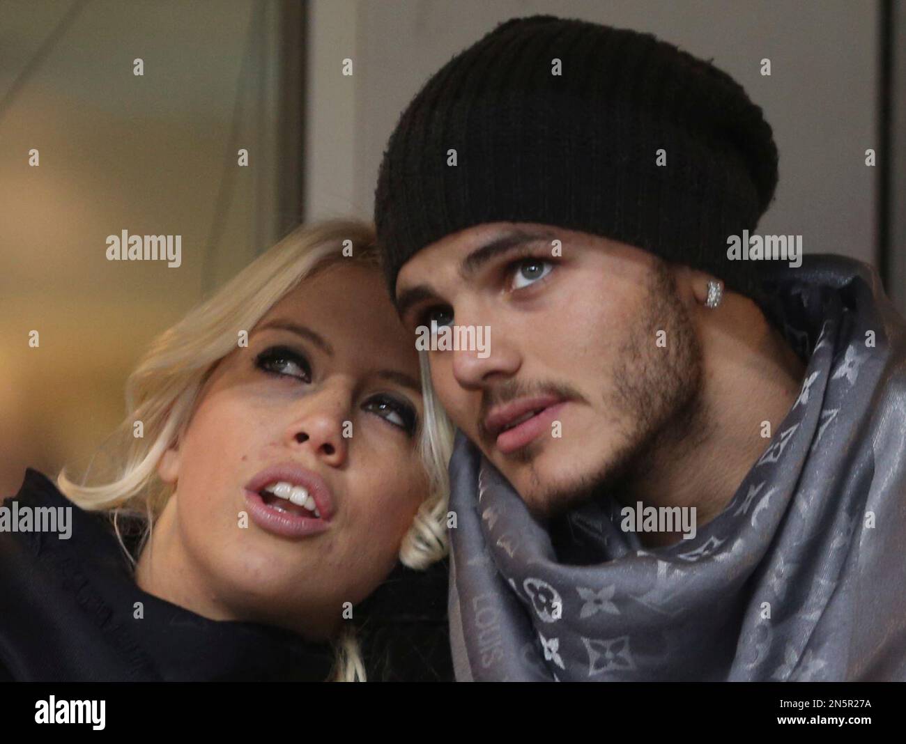 Inter Milan forward Mauro Icardi, of Argentina, is flanked by Argentine  model Wanda Nara as they sit in the stands prior to a Serie A soccer match  between Inter Milan and Chievo,