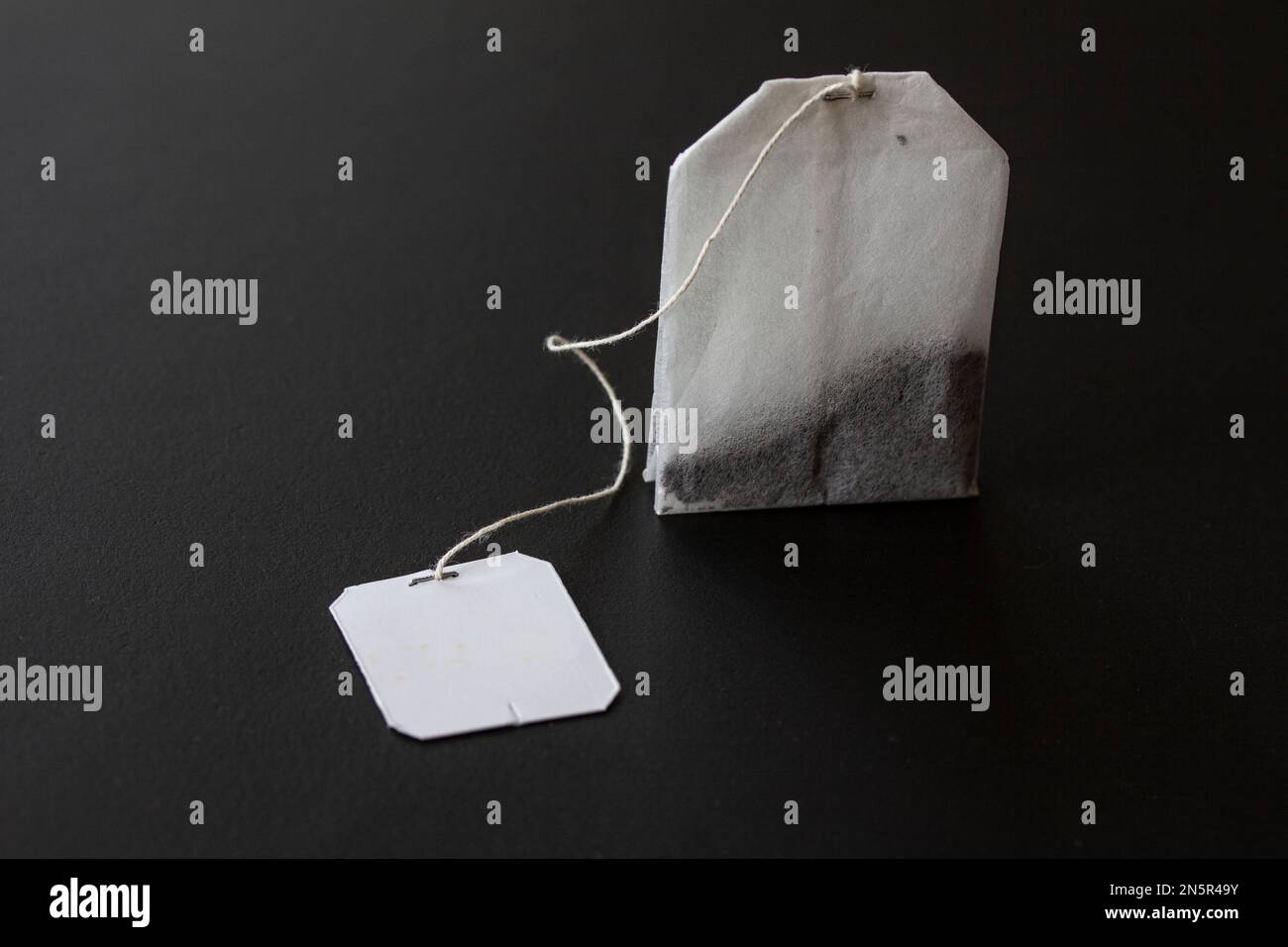 Tea bag on black background. Close up image. Stock Photo