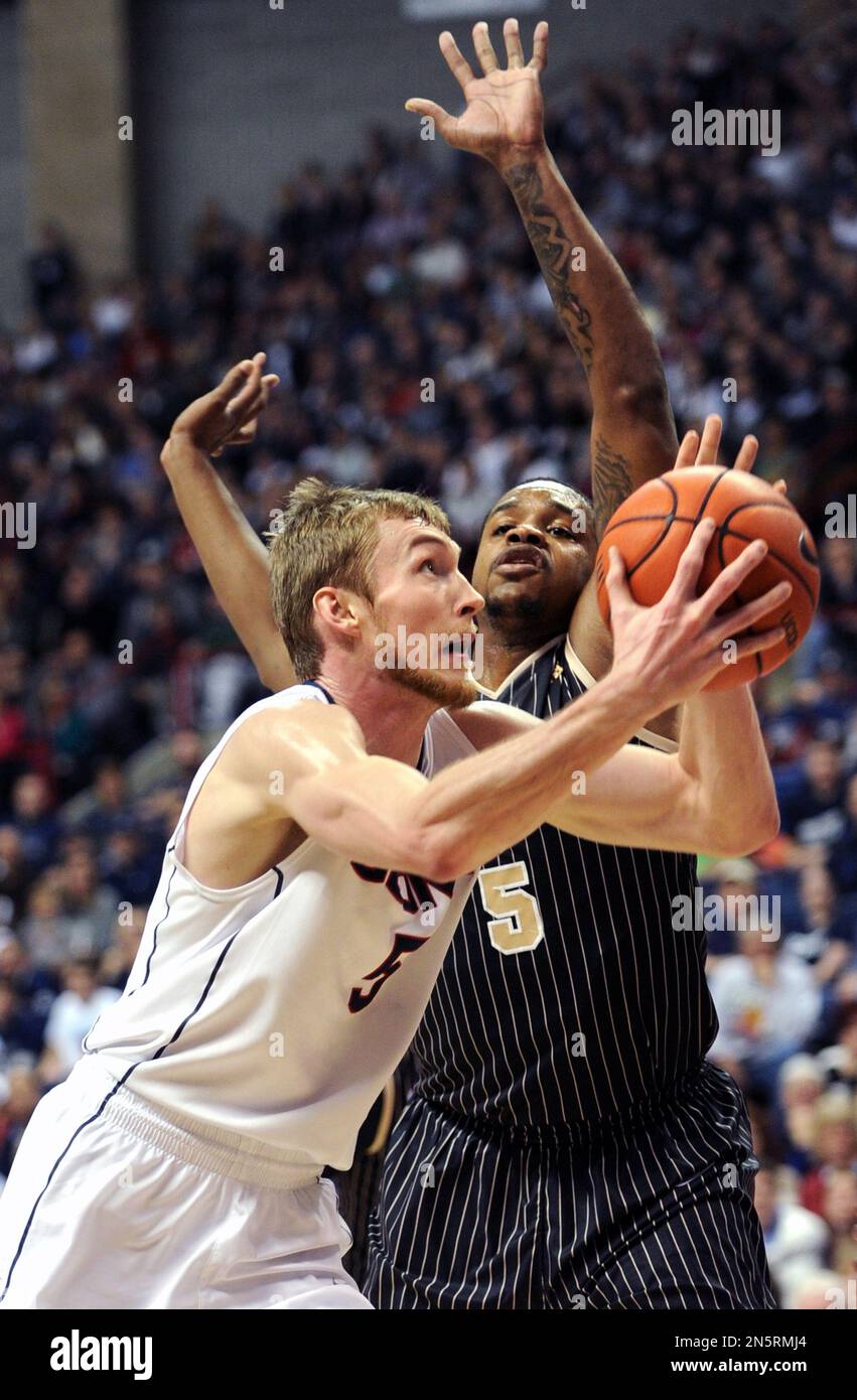 Connecticut's Niels Giffey (5) drives to the basket past Central