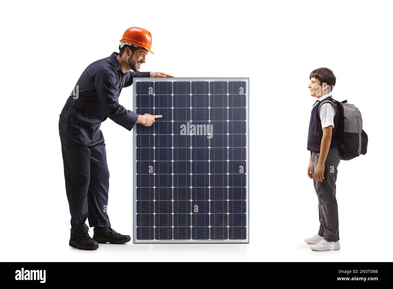 Worker in a uniform and helmet showing a solar panel to a schoolboy isolated on white background Stock Photo