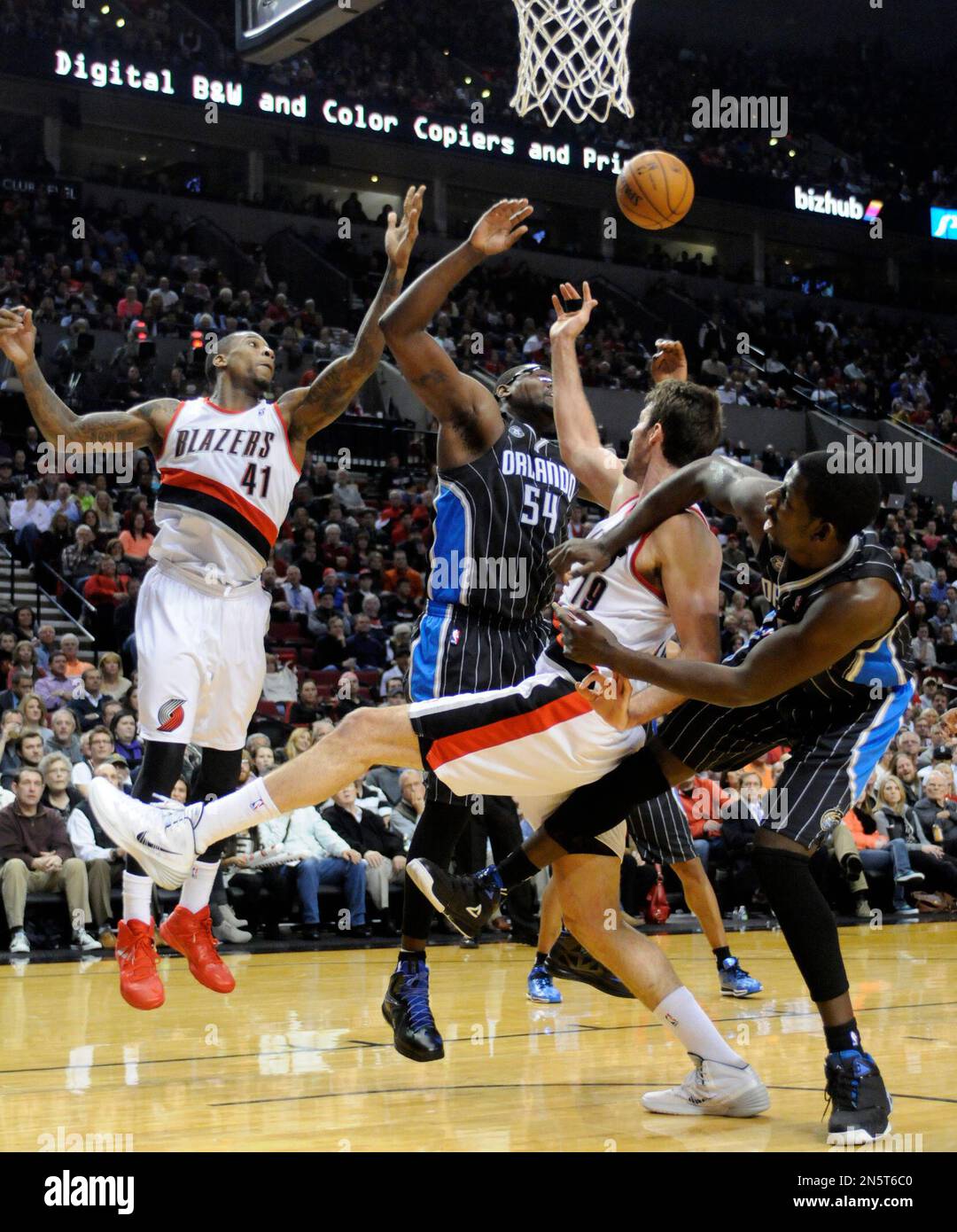 The Portland Trail Blazers' Thomas Robinson (41) and Joel Freeland (19)  battle for offensive rebounds against the Orlando Magic's Jason Maxiell  (54) and Andrew Nicholson (44) during the second half of an, image size:1080x1390