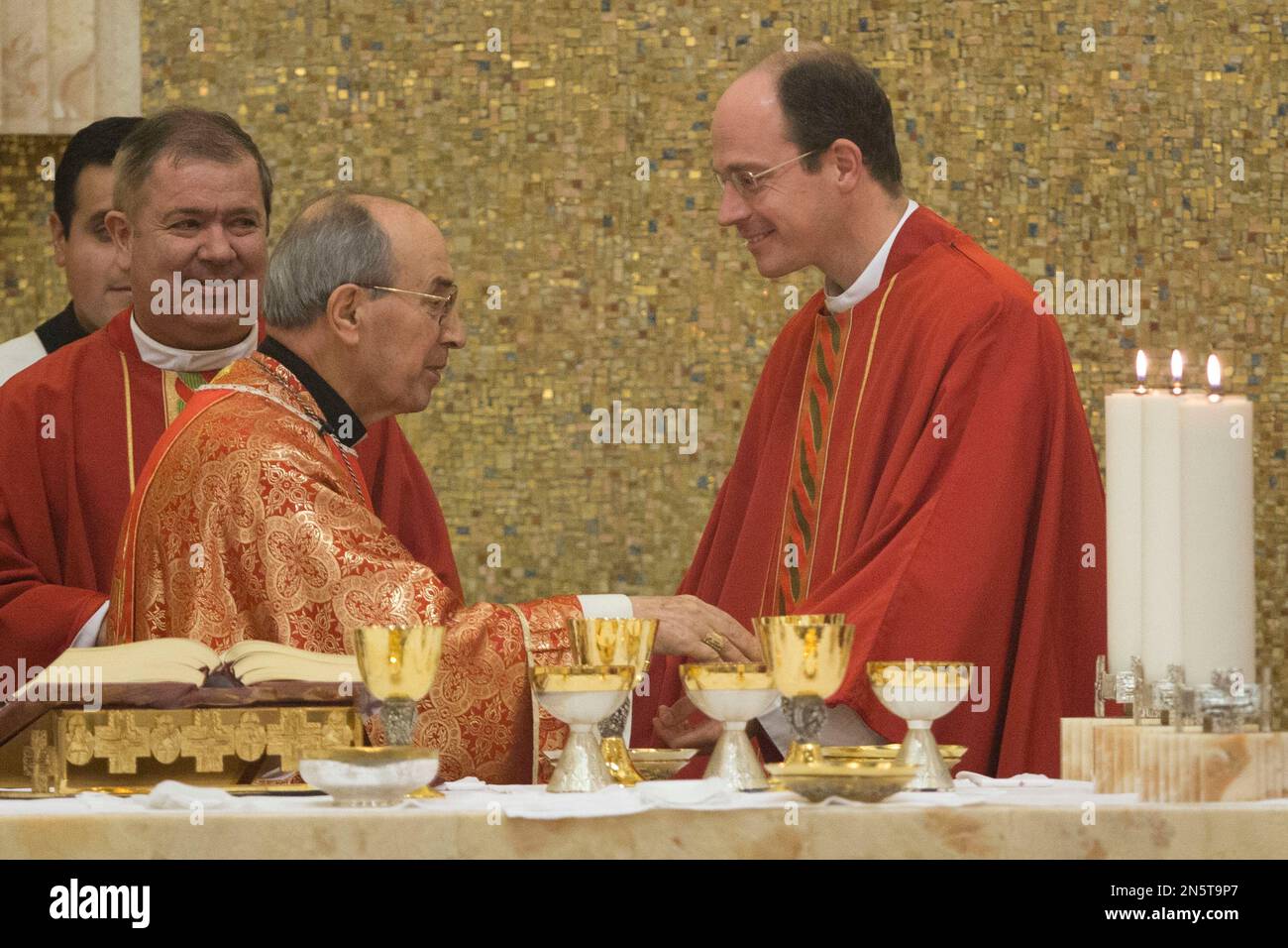 Cardinal Velasio De Paolis, left, exchanges a sign of peace with Legion ...