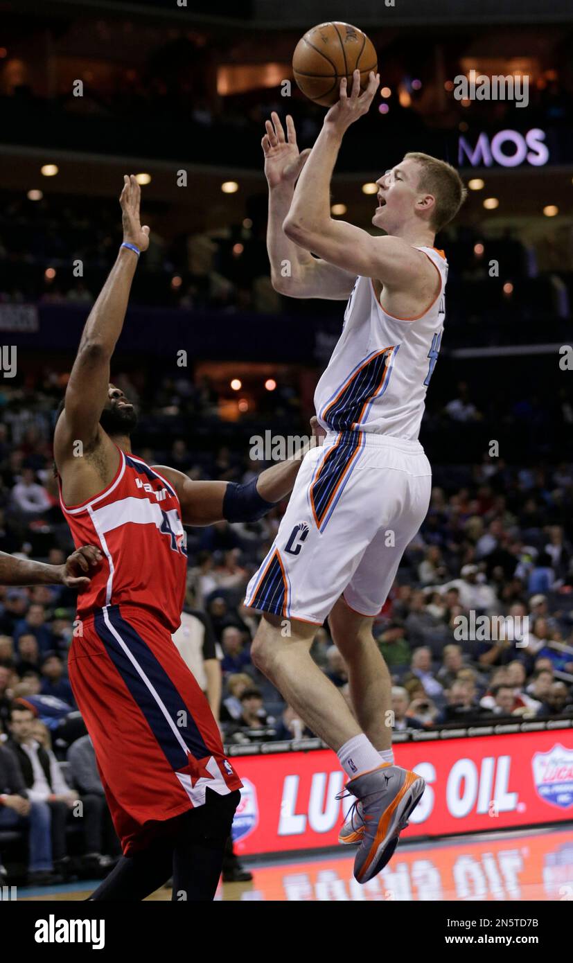 Charlotte Bobcats' Cody Zeller, right, shoots over Washington Wizards