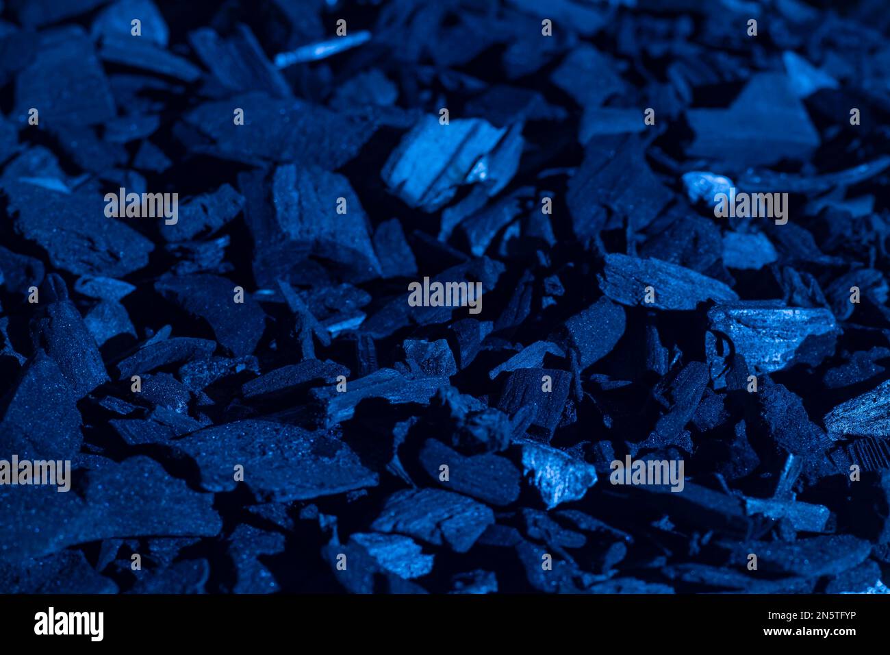 Natural black charcoal with a blue tint. Industrial coal. Pile of black