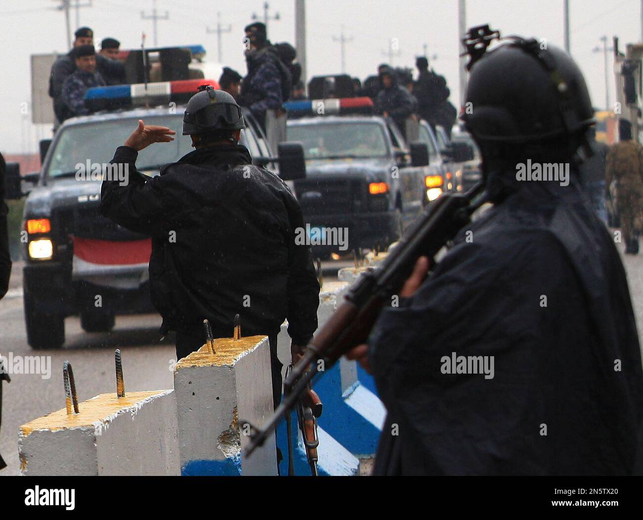 Basra riot police unit convoy returns to its headquarters from the ...