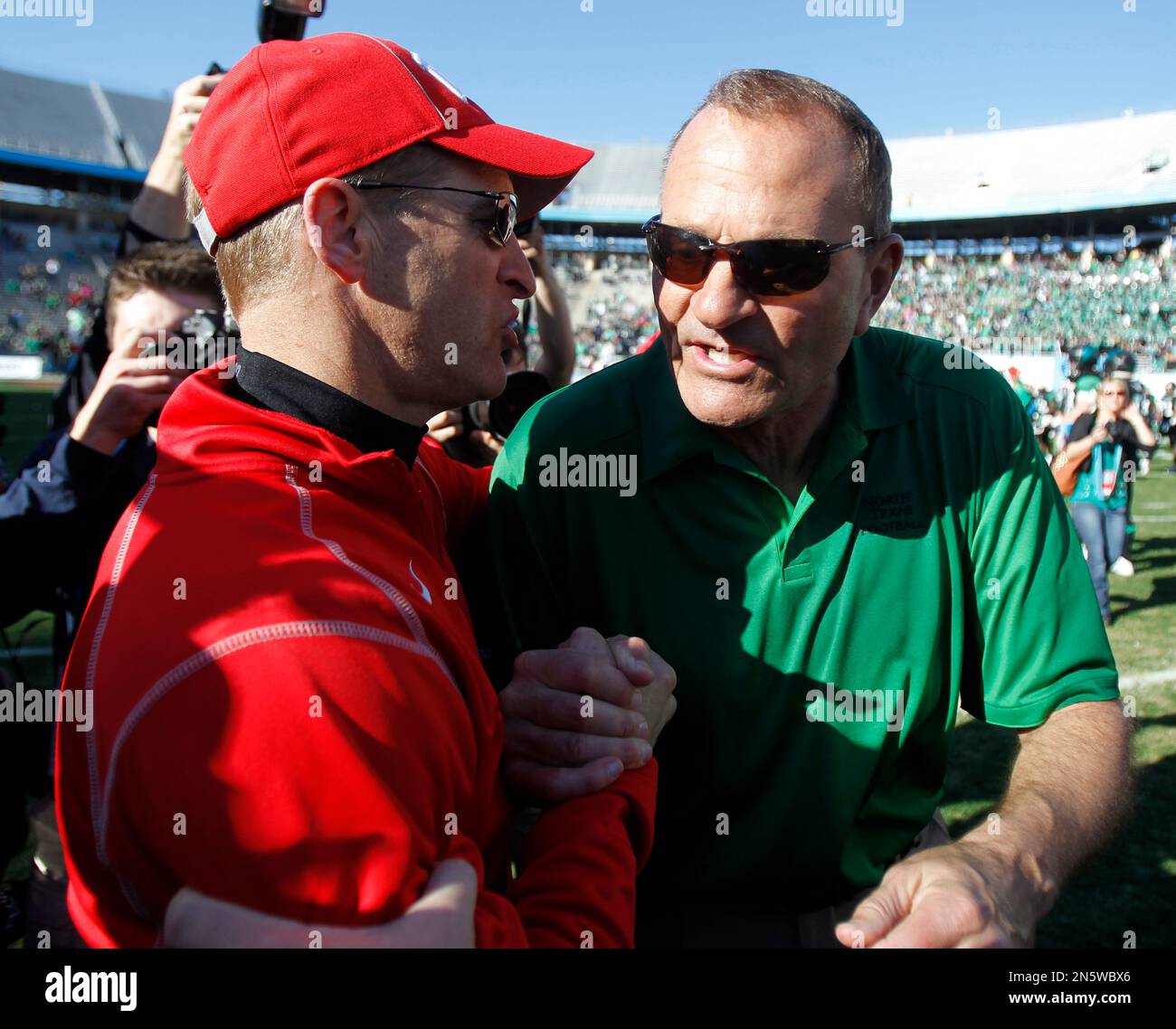 UNLV head coach Bobby Hauck, left, and North Texas head coach Dan