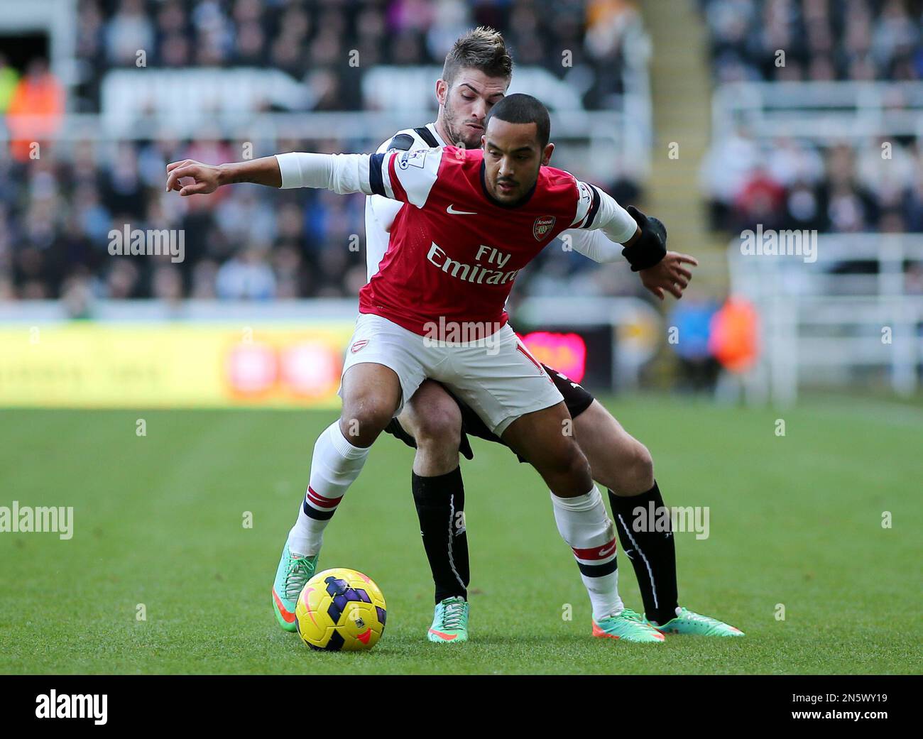 Newcastle United's Davide Santon, left, vies for the ball with Arsenal