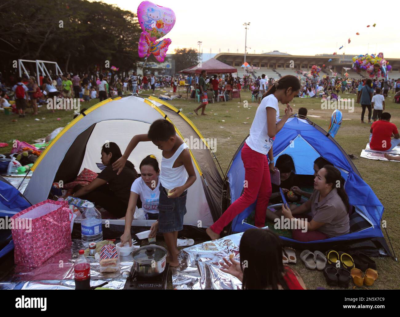 A Filipino family stays inside tents at Manila's Rizal Park, Philippines as they celebrate
