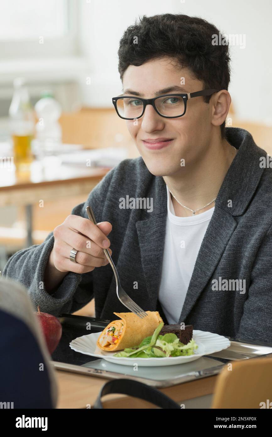 University student eating lunch in canteen School, Bavaria, Germany
