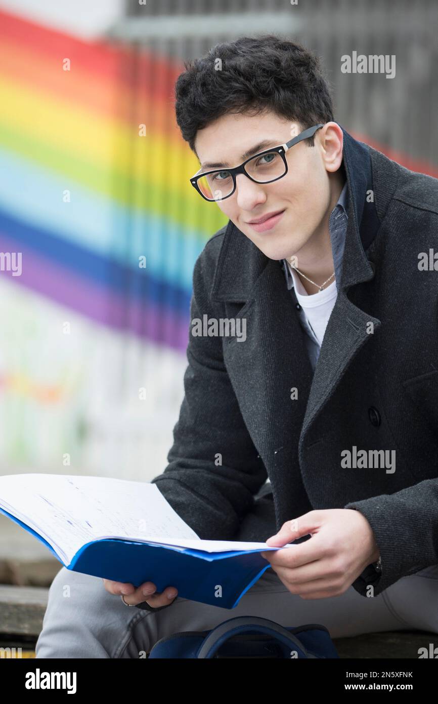 University student reading book in campus School, Bavaria, Germany Stock Photo