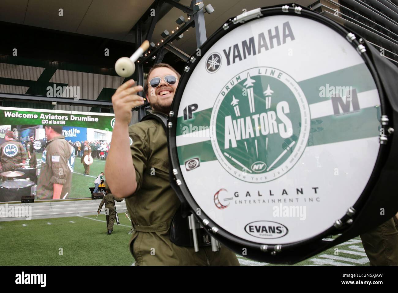 A member of the Aviators Drum Line perform before an NFL football game  between the New York Jets and the Cleveland Browns Sunday, Dec. 22, 2013,  in East Rutherford, N.J. (AP Photo/Peter