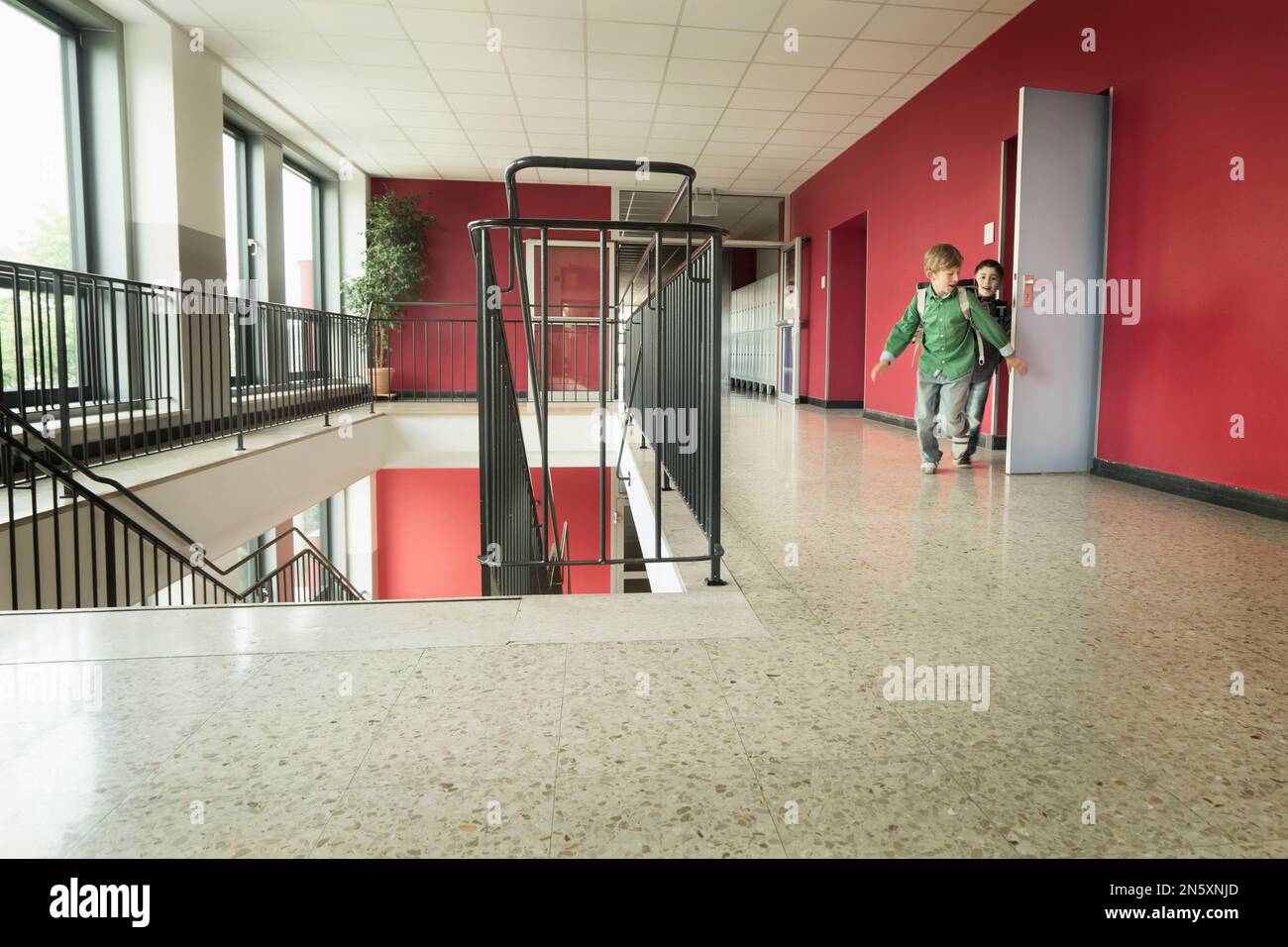 Schoolboys running out of classroom, Bavaria, Germany Stock Photo