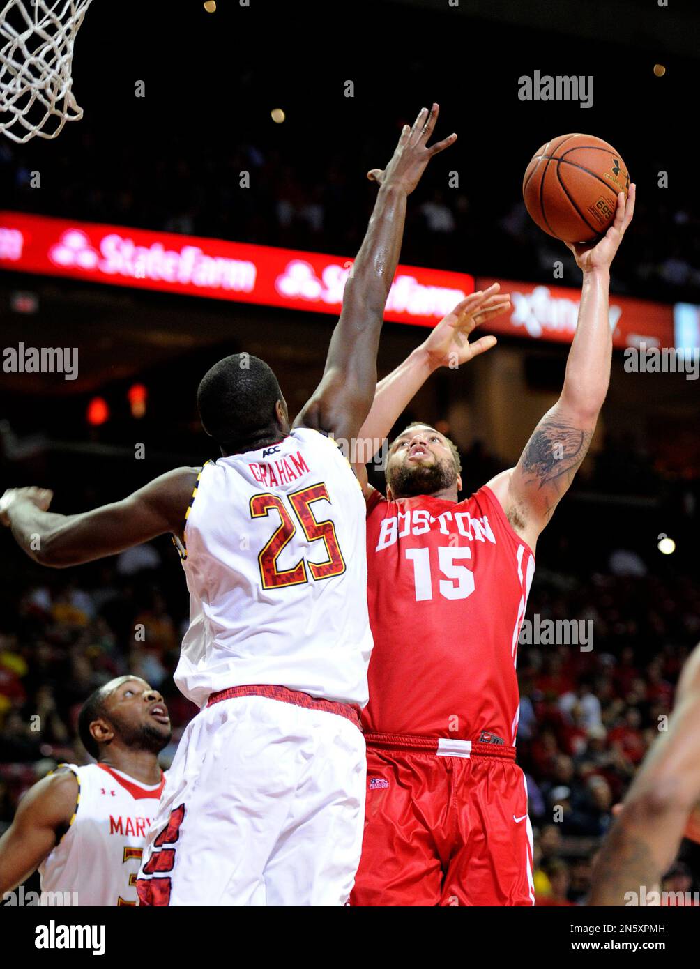 Boston University forward Dom Morris (15) goes to the basket against