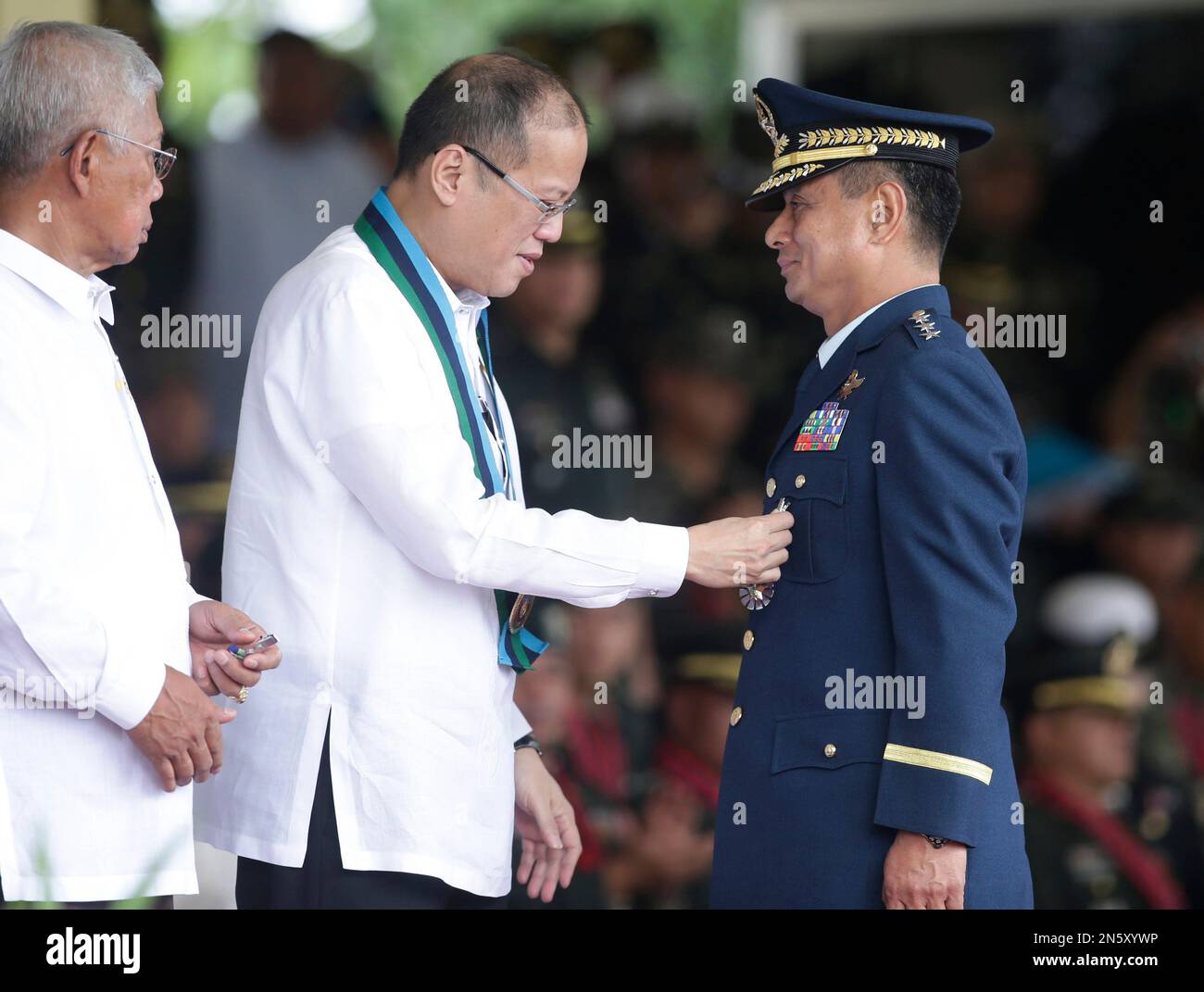 Philippine President Benigno Aquino III , center, pins a medal on Air ...