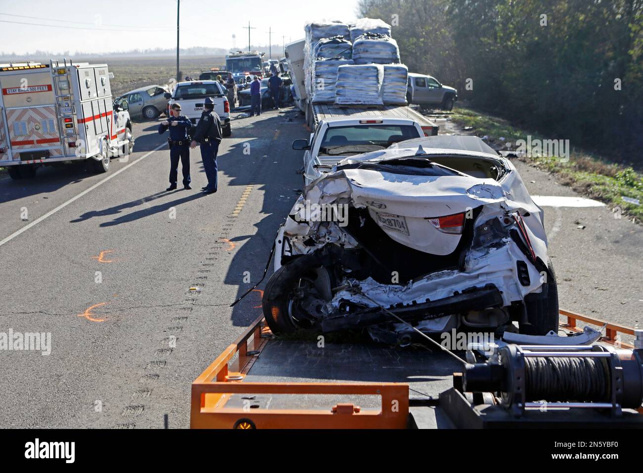 Emergency personnel work at the scene of a multicar accident that