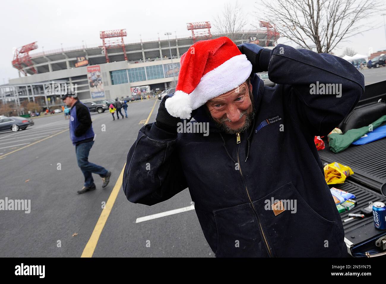 Tennessee Titans fan Eddie Russell puts on a Santa Claus hat