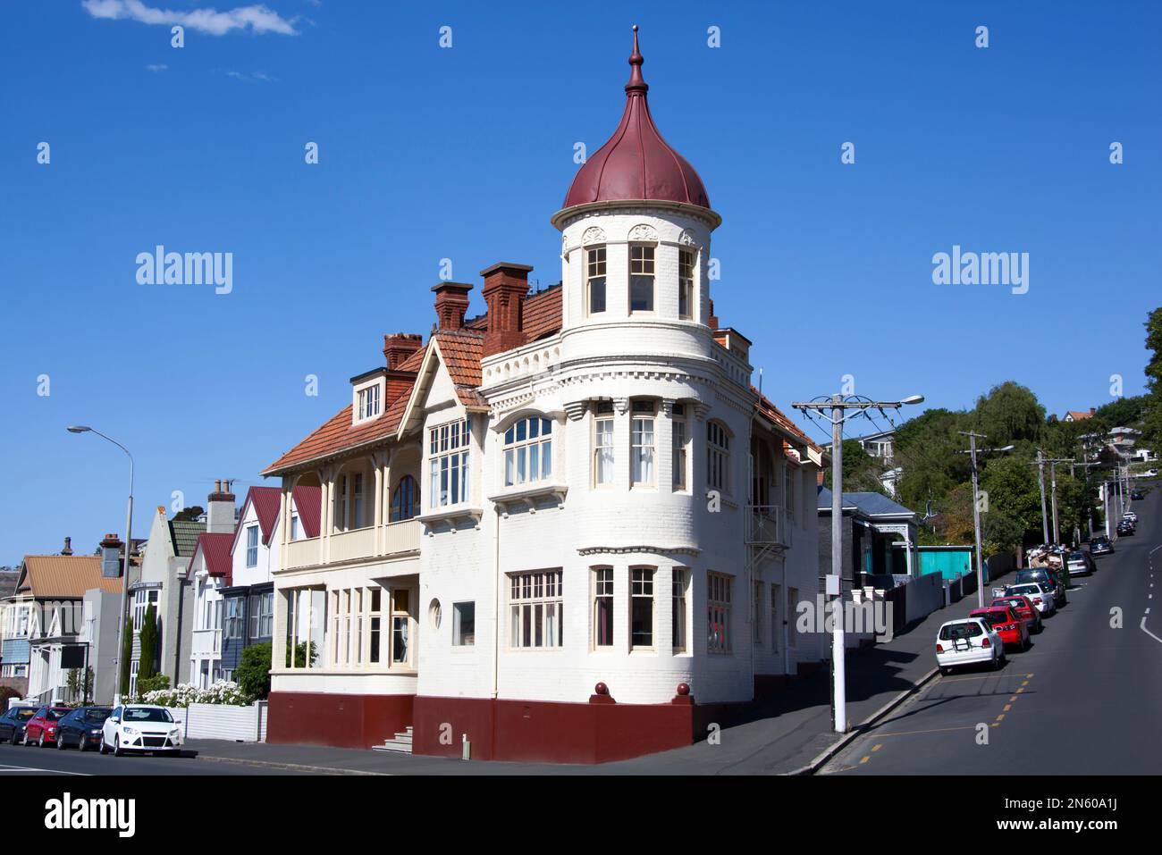 The view of a residential houses and a steep street in Dunedin city (New Zealand). Stock Photo