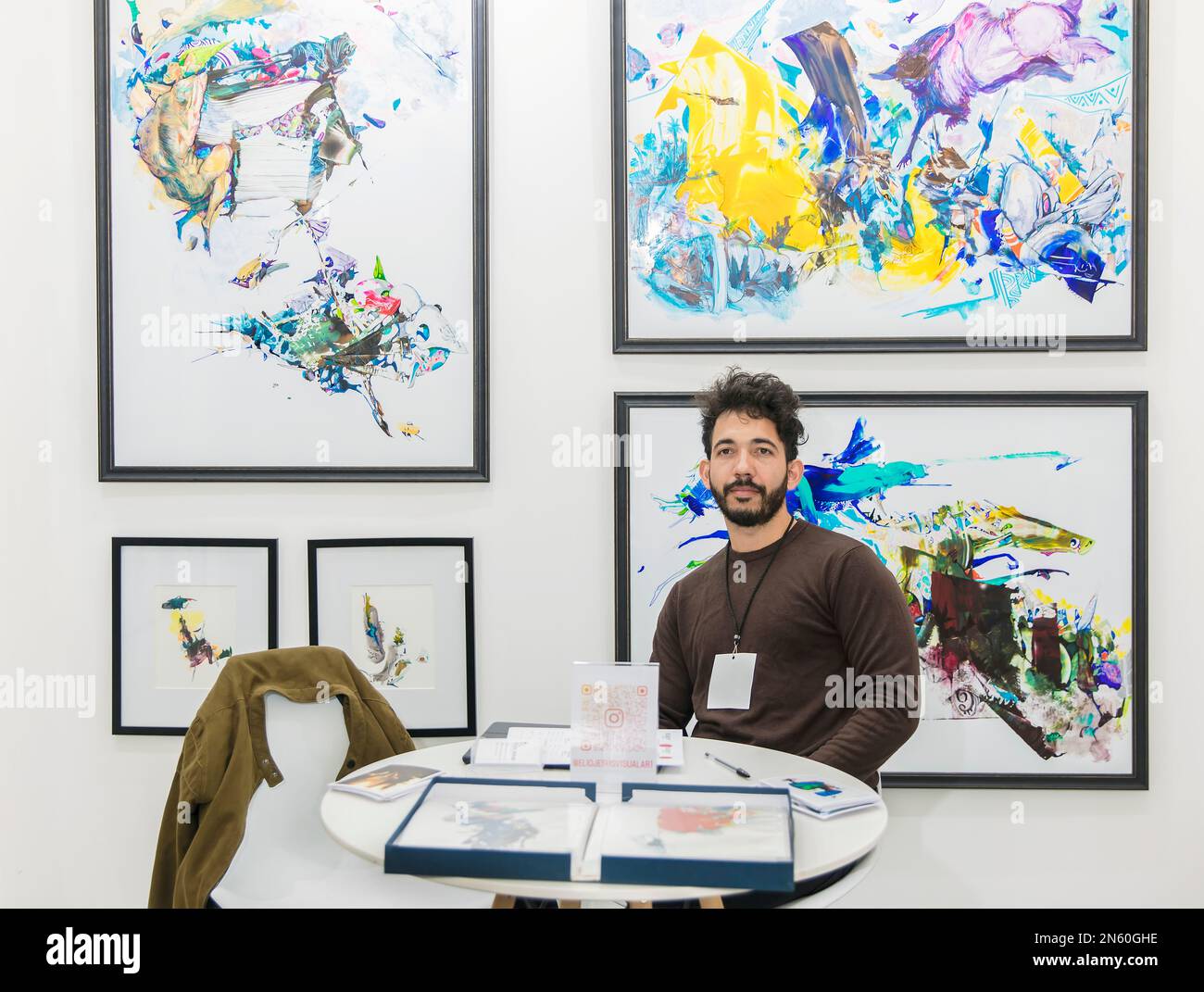 Artist Elio Jesus with some of his works at the BADA 2023 event in Mexico City where artists sell their works directly to buyers without the intervent Stock Photo