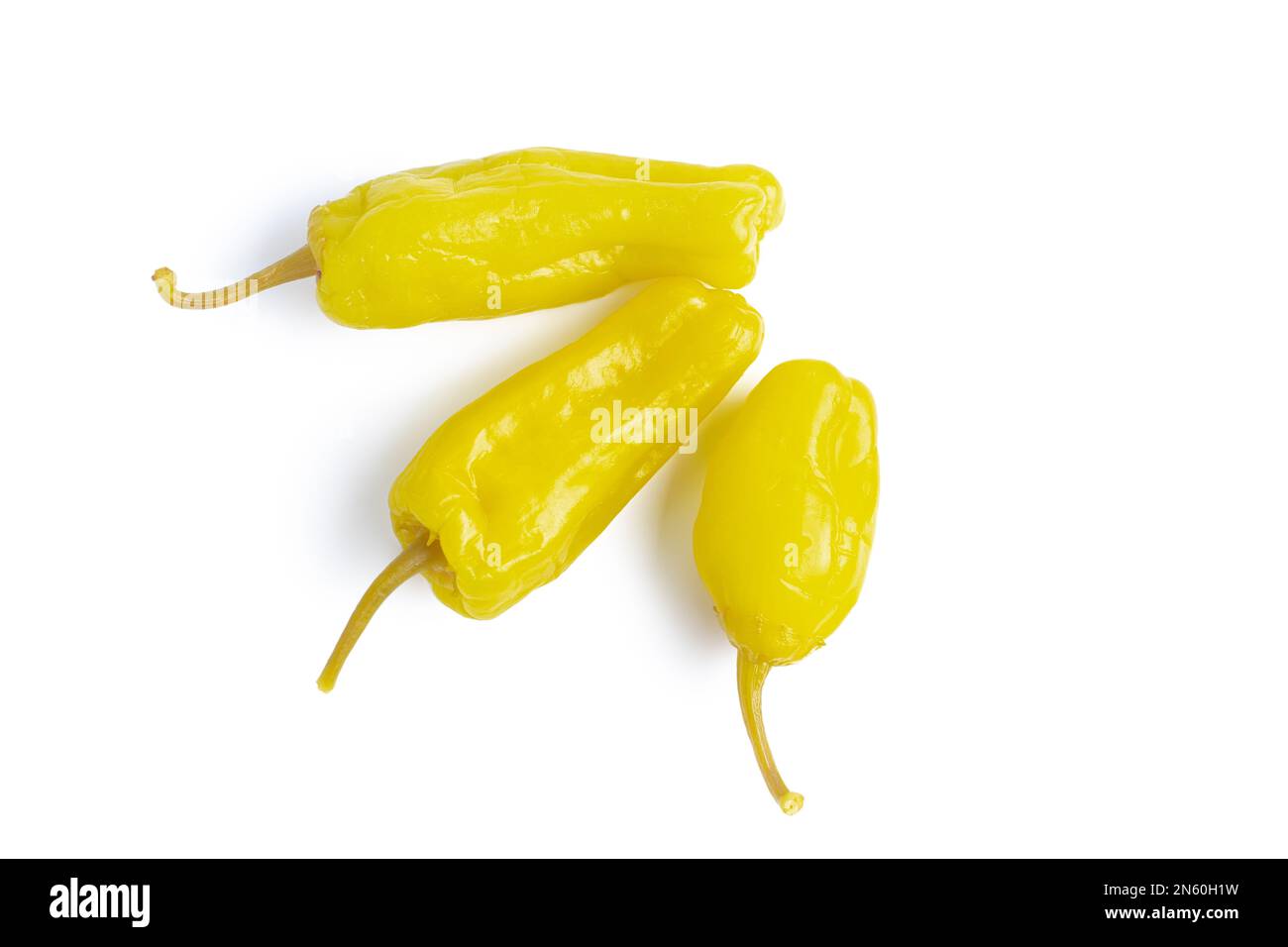 Three pickled yellow peppers, pepperoncini or friggitelli isolated on