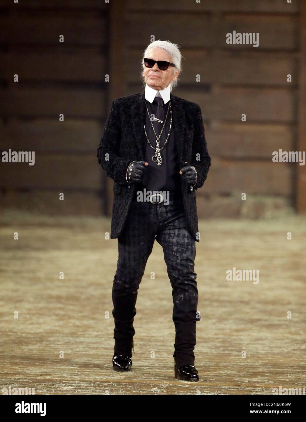 A model walks the runway at Chanel's Metiers d'Art fashion show, in Dallas,  Tuesday, Dec. 10, 2013. For more than a decade, designer Karl Lagerfeld has  picked a city linked to the