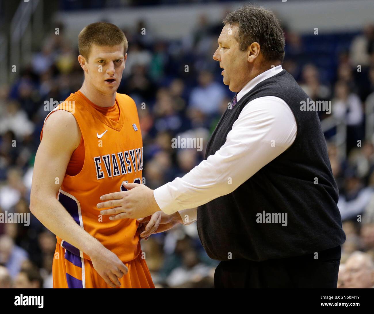 Evansville head coach Marty Simmons, right, talks with guard Adam Wing