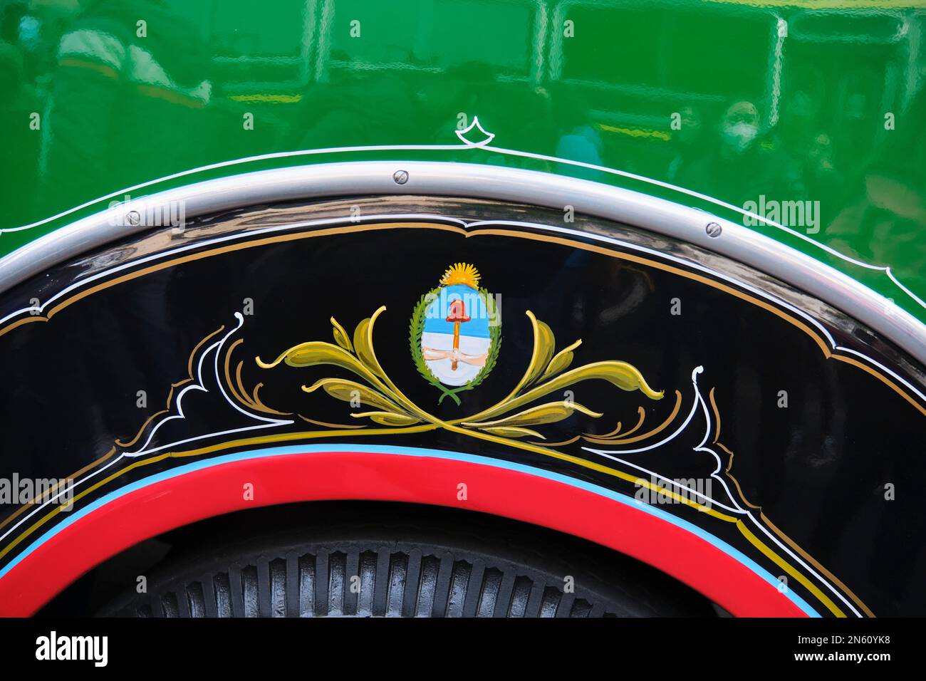 Buenos Aires, Argentina, June 20, 2022: Decorative detail on the bodywork of a 1942 Chevrolet bus, line 45. Argentine National shield in the fileteado Stock Photo