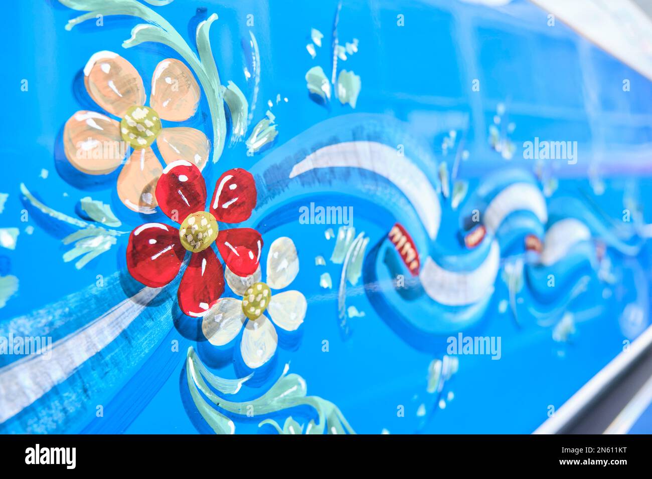 Buenos Aires, Argentina, June 20, 2022: Detail of a restored classic Mercedes Benz bus painted with ornaments, flag ribbons and flowers, in the filete Stock Photo
