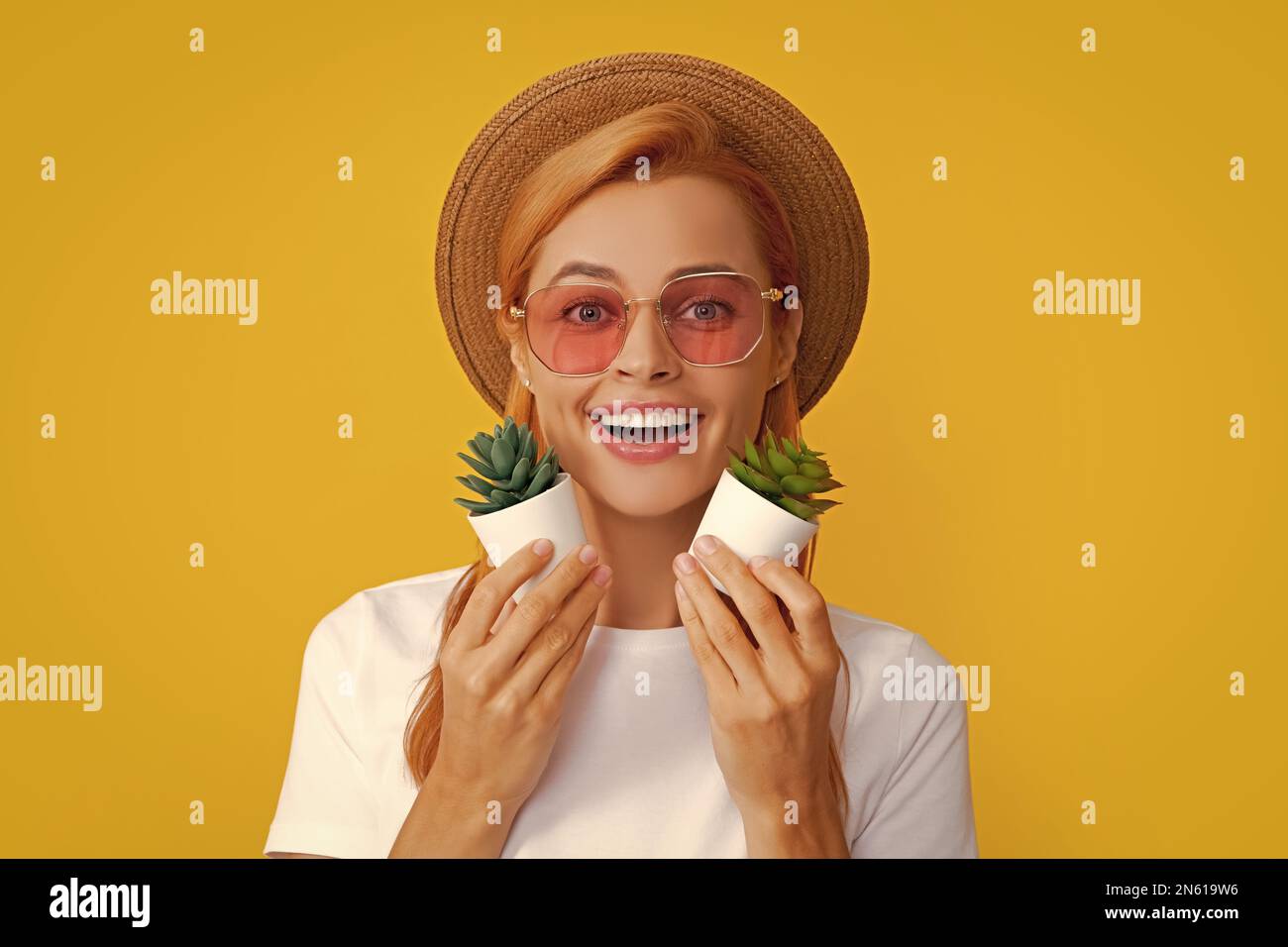  Beautiful woman holding small cactus, happy and smile Stock Photo - Alamy