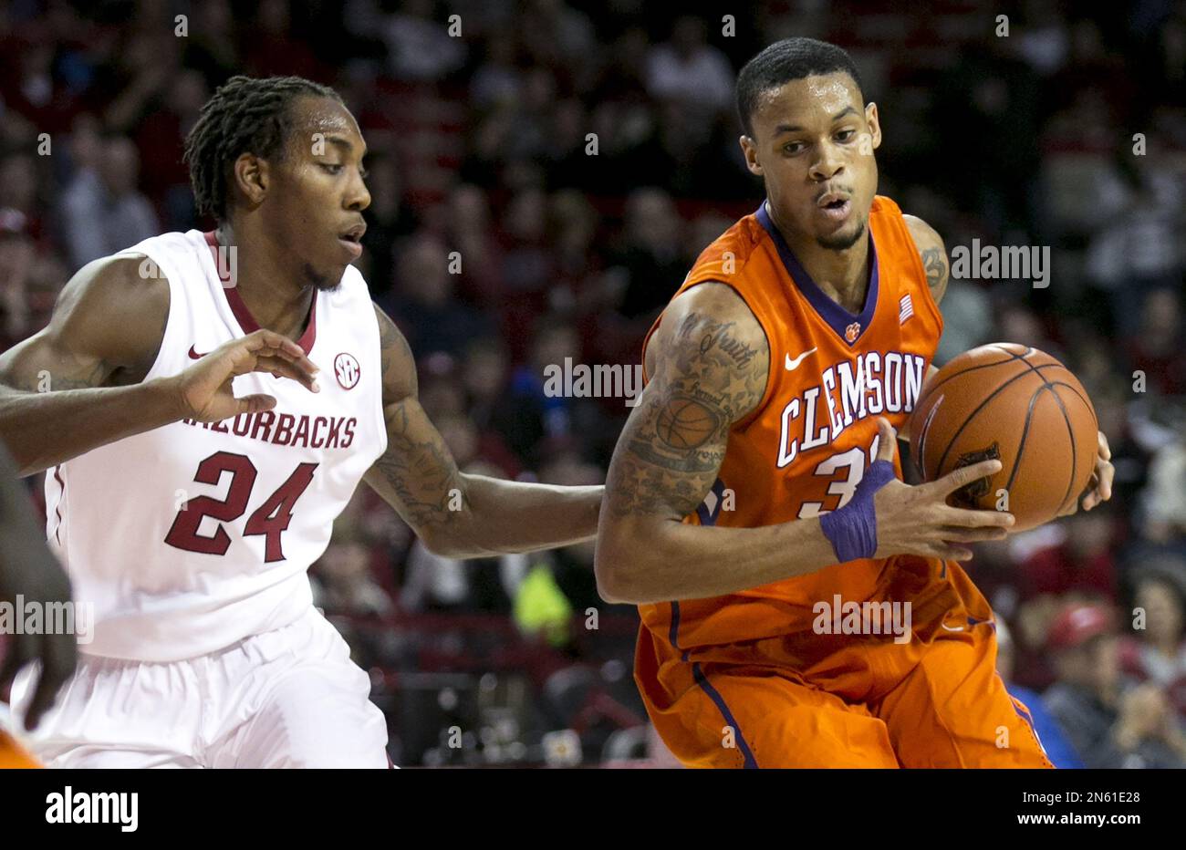 Clemson forward K.J. McDaniels, right, drives to the basket against