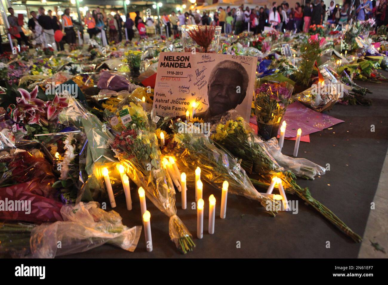 Flowers, candles and condolence messages are seen in Nelson Mandela Square in Sandton