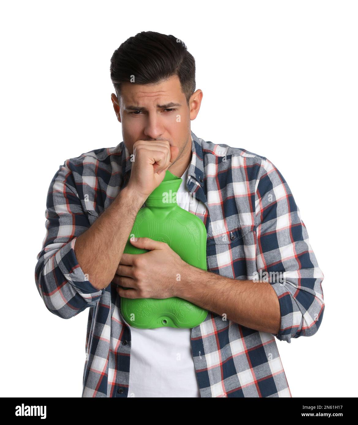 Ill man with hot water bottle coughing on white background Stock Photo